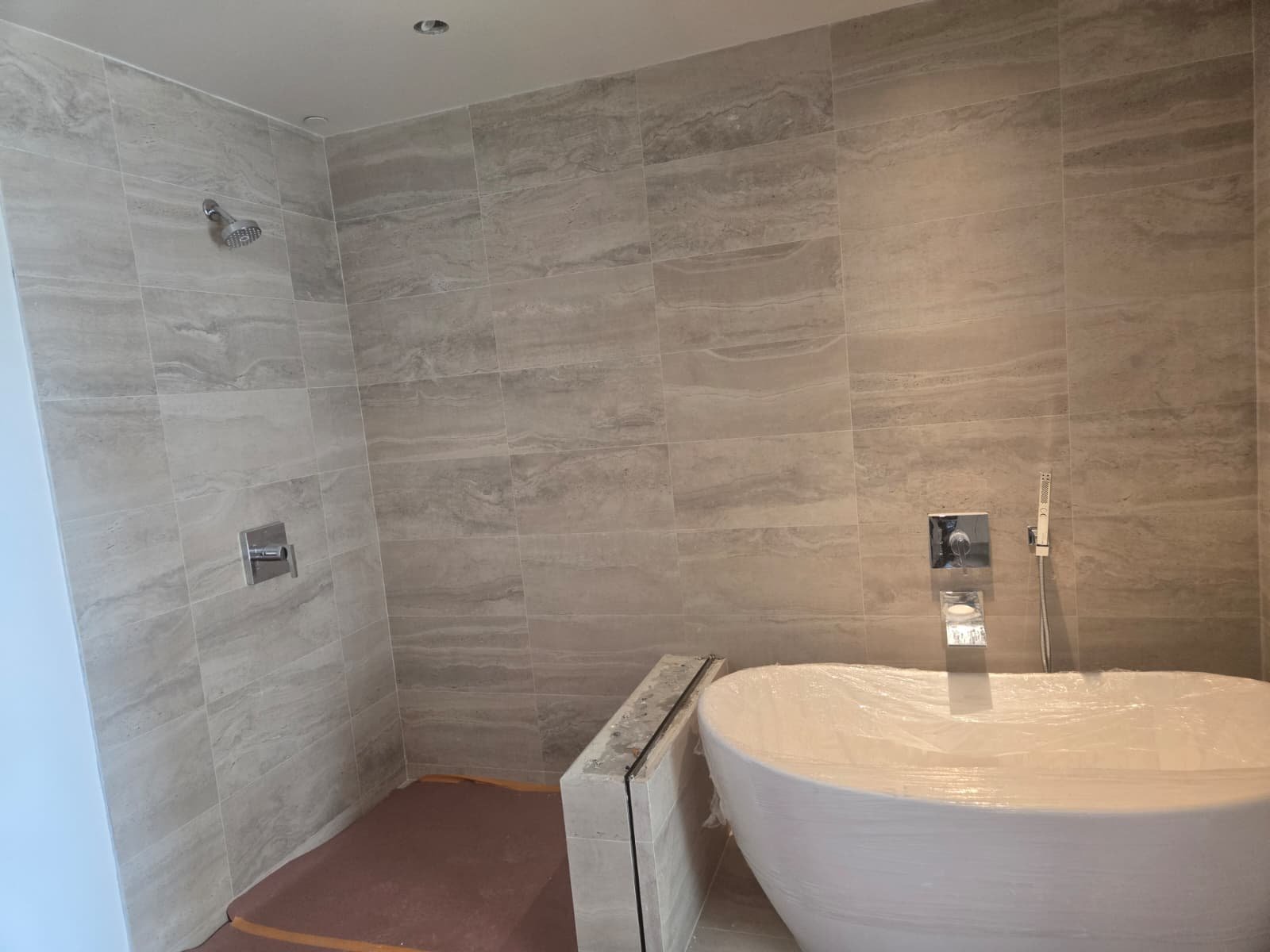 Luxury freestanding soaking tub and porcelain shower transformation in Los Angeles by Ararat Builders Corp